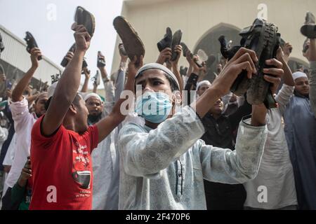 Dhaka, Bangladesh. 19th Mar, 2021. Protesters chant slogans while holding footwears during the protest.Bangladeshis raise their footwear and shout slogans during a protest after Friday prayers, against the visit of Indian Prime Minister Narendra Modi in Dhaka, Bangladesh, Modi is expected to visit Bangladesh on 26 march to attend the 50th anniversary of Independence Day of Bangladesh as well as the 100th birth anniversary of the country's first president Sheikh Mujibur Rahman. Credit: SOPA Images Limited/Alamy Live News Stock Photo