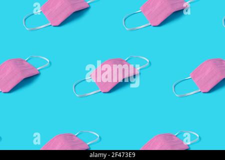 Pattern made with a medical surgical masks for corona virus protection. Minimal Coronavirus outbreak. Global pandemic concept. Stock Photo
