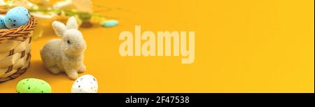 Banner cute bunny with colorful ester eggs in nests, spring and festive background photo Stock Photo