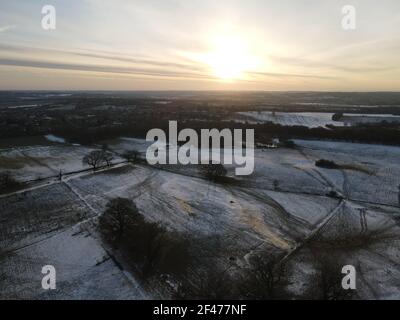 Snow covered fields in Essex UK at sunrise aerial image Stock Photo