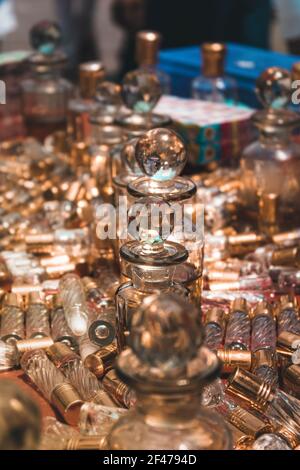 A vertical shot of vintage old-fashioned containers for a perfume made of glass. Stock Photo