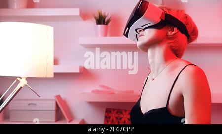 Young woman using VR glasses. Virtual dating. High quality photo Stock Photo