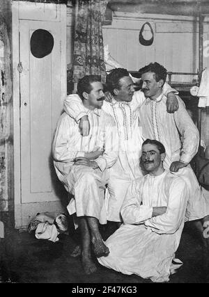 Cruises of the Hamburg America line, around 1911/1913. Group picture with young men in night giving in their sleeping cabin of a high sea passenger steamer, guess. Pennsylvania Cruises of the Hamburg America line, around 1911/1913. Group picture with young men in nightwear in their sleeping cabin of a high sea passenger steamer, presumably the 'Pennsylvania Stock Photo