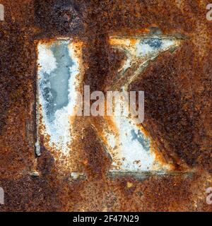 Remains of the letter K on rusty metal plate Stock Photo