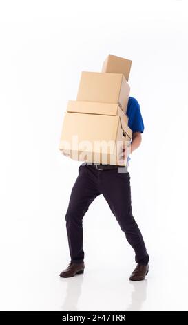 young Asian delivery man in blue uniform, carrry cardboard box in hands isolated on white background. Delivery concept Stock Photo