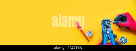 Electrical installation measuring instruments tools on a yellow background with copy space. place for text. Selective focus Stock Photo