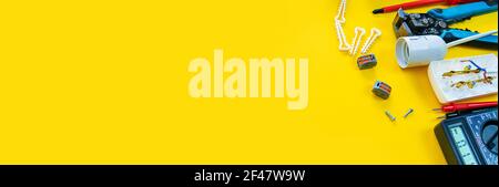 Electrical installation measuring instruments tools on a yellow background with copy space. place for text. Selective focus Stock Photo