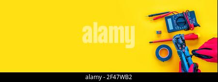Electrical installation measuring instruments tools on a yellow background with copy space. place for text. Stock Photo