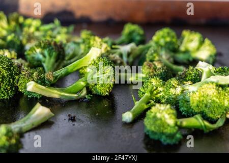 Grilled broccoli on a flat outdoor griddle Stock Photo