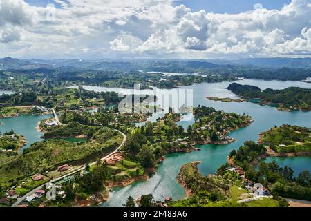 View of Guatape from the top of El Penon onto the artificial lake with its turquoise water and lagoons Stock Photo