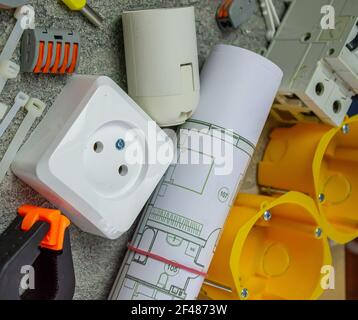 Electrical tools and a set of components for use in electrical installations on a gray background with a place for text Stock Photo