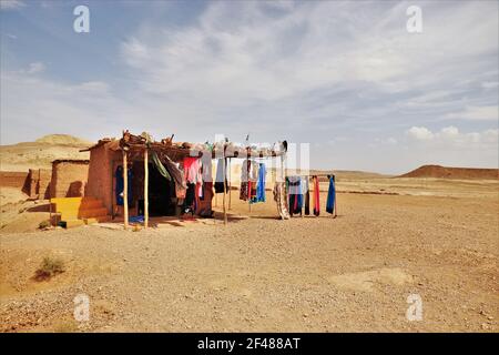 Souvenir Hut Selling Scarves in the Middle of the Moroccan Dessert in the Atlas Mountains Near Ait Benhaddou, Morocco Stock Photo