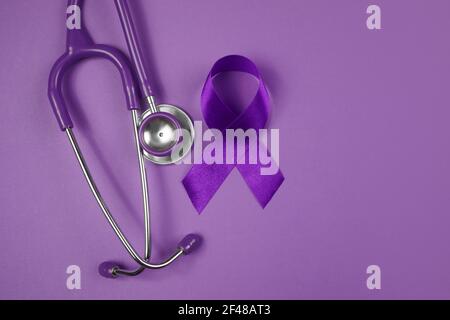 Purple day. World epilepsy day. Purple ribbon on purple background Stock Photo