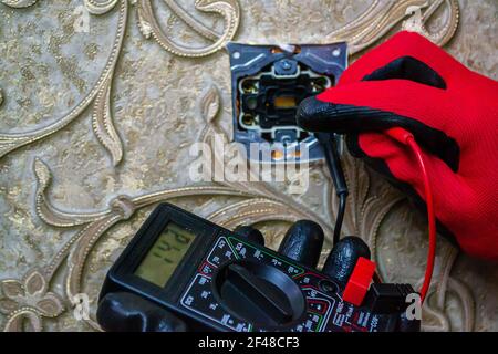 Repair of the socket, socket. Tools, voltage measuring devices. selective focus. Stock Photo