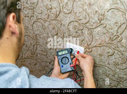 Repair of the socket, socket. Tools, voltage measuring devices. selective focus. Stock Photo