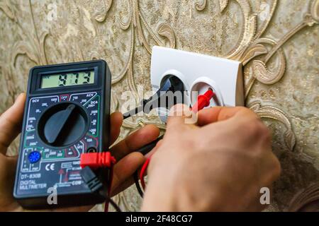 Repair of the socket, socket. Tools, voltage measuring devices. selective focus. Stock Photo