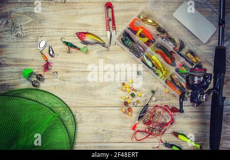 lot of colorful lures with the fishing rod on the wooden pier Stock Photo -  Alamy