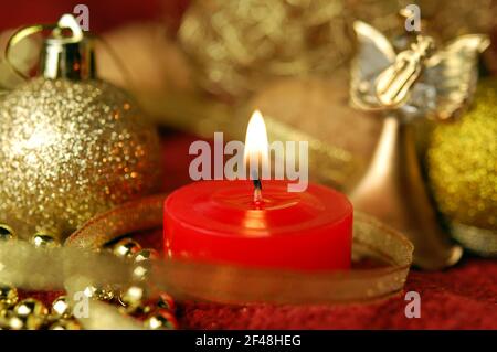 Candle and Christmas decoration. Focus on a wick. New Year or Christmas greeting card. Stock Photo