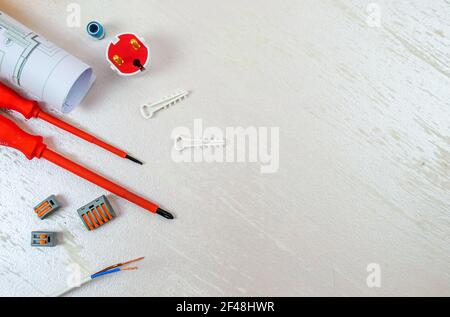 Flat composition with electrician tools on white background. Place for text. Selective focus. Stock Photo