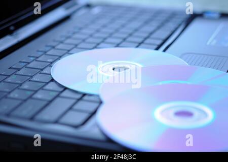Three DVD disk on a laptop keyboard. Stock Photo