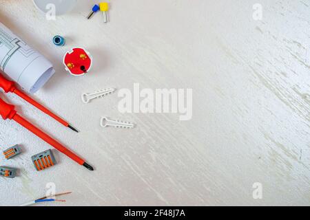 Flat composition with electrician tools on white background. Place for text. Selective focus. Stock Photo
