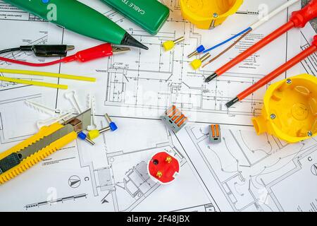 Flat lay composition with electrician's tools on house plan. Space for text.Selective focus. Stock Photo