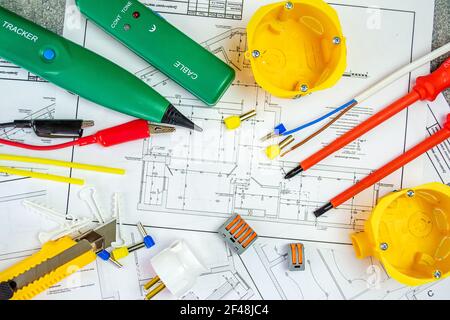 Flat lay composition with electrician's tools on house plan. Space for text.Selective focus. Stock Photo