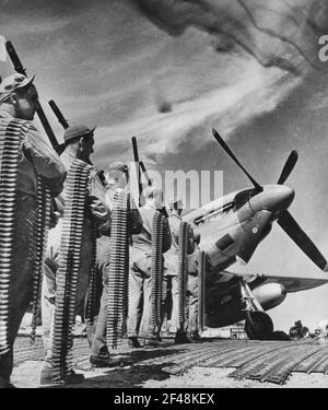 FIRE POWER OF THE P-51 MUSTANG FIGHTER. These are the six .50 calibre machine guns used in the new U.S. Army 8th Air force P-51 Mustang fighters. The cartridge belts being carried represent the amount used by only ONE gun on a flight Stock Photo