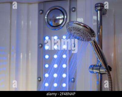 Bathroom shower head spraying water Stock Photo