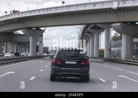 Off-road car moving on the highway in the city under the overpass Stock Photo