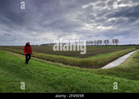 Walker at the Sir Peter Scott Lighthouse, known as the East Lighthouse, River Nene, Sutton Bridge village, South Holland district, Lincolnshire, Engla Stock Photo