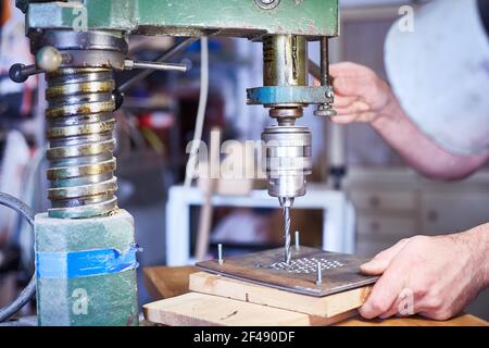 Close-up. hand heavy industrial worker is working on metal work factory process by performing mechanical turning operation at machine for steel struct Stock Photo