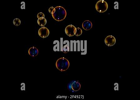 Rainbow soap bubbles on black background Stock Photo
