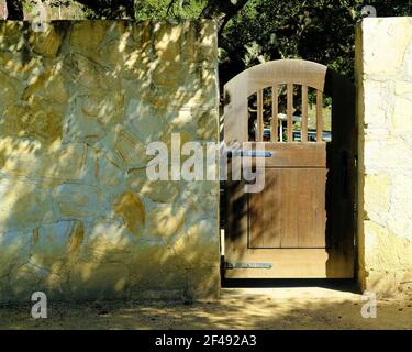 Dark brown wooden gate; hacienda style decor and design; Holman Ranch, Carmel Valley, California, USA. Stock Photo