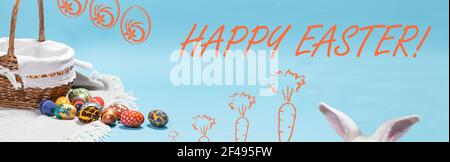 Beautiful Easter horizontal long banner with a basket of eggs and bunny ears with the inscription Happy Easter on a light minimalist blue background Stock Photo