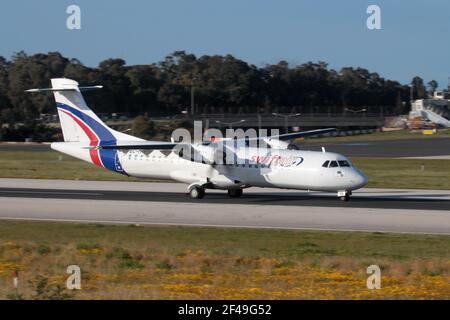 Swiftair ATR 72 propeller powered cargo plane on the runway while departing from Malta. Turboprop commercial airplane. Stock Photo