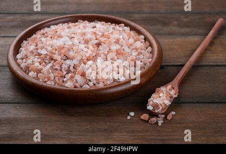 Himalayan pink salt on wooden plate and spoon. Stock Photo