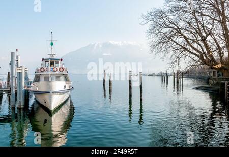 Ferry boat at the pier on the shore of lake Maggiore in Locarno, Switzerland Stock Photo