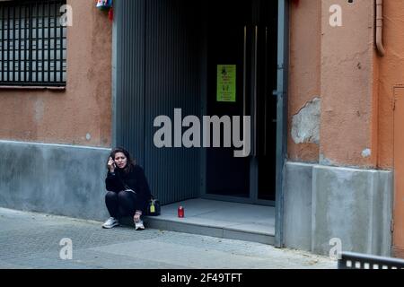 Woman sat on outside step talking on the phone. Stock Photo