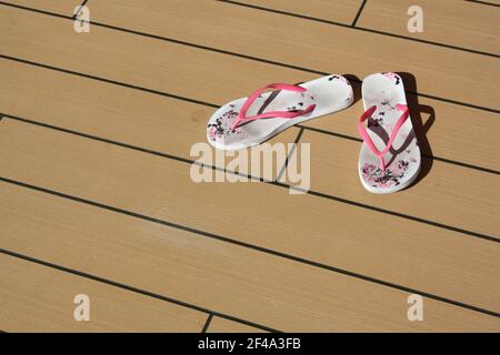 Deck Chair with Filp Flops on deck Stock Photo