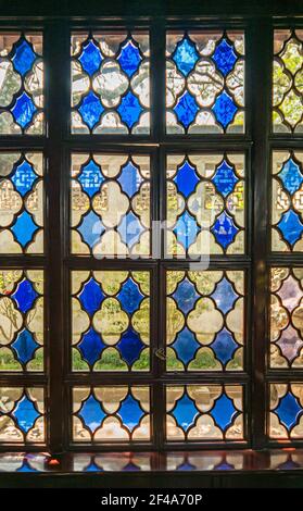 Suzhou, China - May 3, 2010: Humble Administrators Garden. Closeup looking through outside a blue stained glass window. Stock Photo