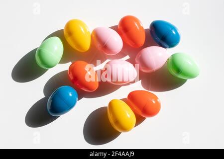 Top view of colorful plastic Easter eggs in the sun isolated on a white background. Stock Photo