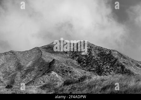 Mountain peak under cloudy skies Stock Photo - Alamy