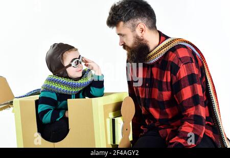 Kid Travel on Toy Airplane. Child Sitting in plane. Son playing Pilot with father. Stock Photo
