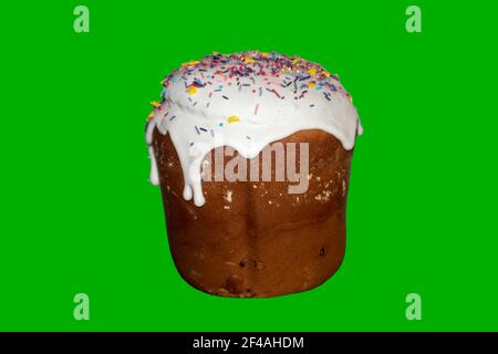 Easter holidays isolated sweet bread, paska decorated with sweet sugar icing on green background. Orthodox handmade kulich with topping. Spring holida Stock Photo