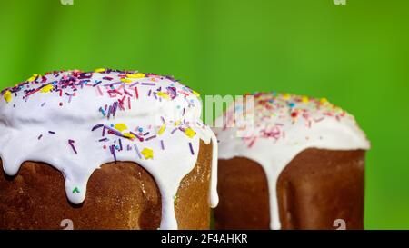 Sugar icing decoration on easter spring holidays sweet bread, paska composition on green with blurred background. Orthodox handmade kulich with toppin Stock Photo