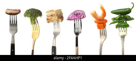 Different food impaled on forks against white background Stock Photo
