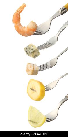 Different food impaled on forks against white background Stock Photo