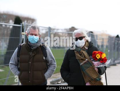 Paris, France. 19th Mar, 2021. People wearing face masks walk in the Champ de Mars in Paris, France, on March 19, 2021. French Prime Minister Jean Castex on Thursday announced 'new massive measures' to curb COVID-19 in the country's 16 worst-hit regions, including Paris. Starting Friday midnight, about 18 million French people in regions such as Paris, Hauts-de-France in the north as well as the Alpes-Maritimes on the Mediterranean should stay at home, Castex announced at a press briefing on the epidemic situation. Credit: Gao Jing/Xinhua/Alamy Live News Stock Photo