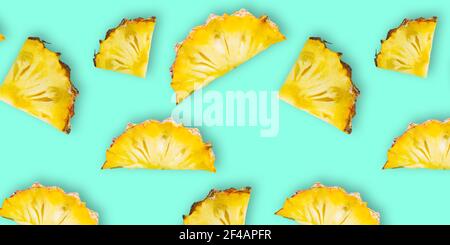 Pattern of fresh ripe pineapple slices isolated on cyan background. Top view Stock Photo